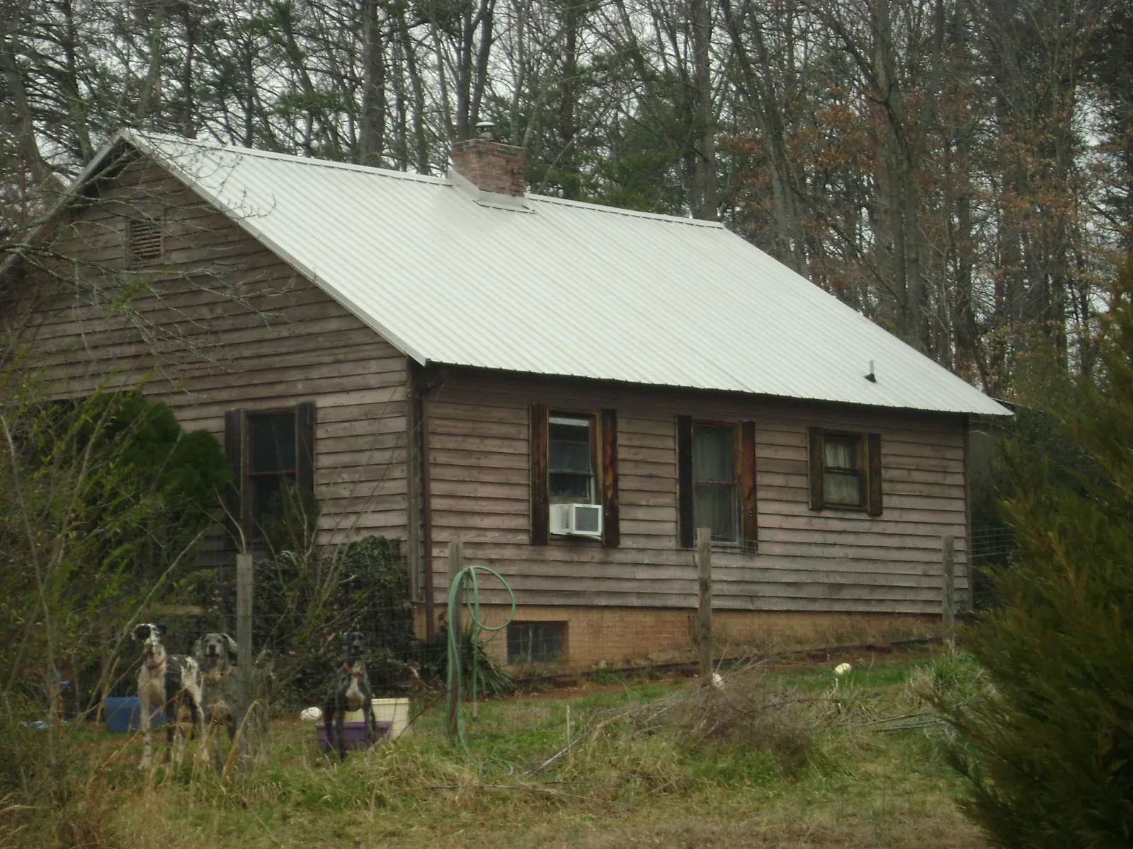 White metal roof on an old wood sided farmhouse, from a Metal Roof Installation job in Coalport